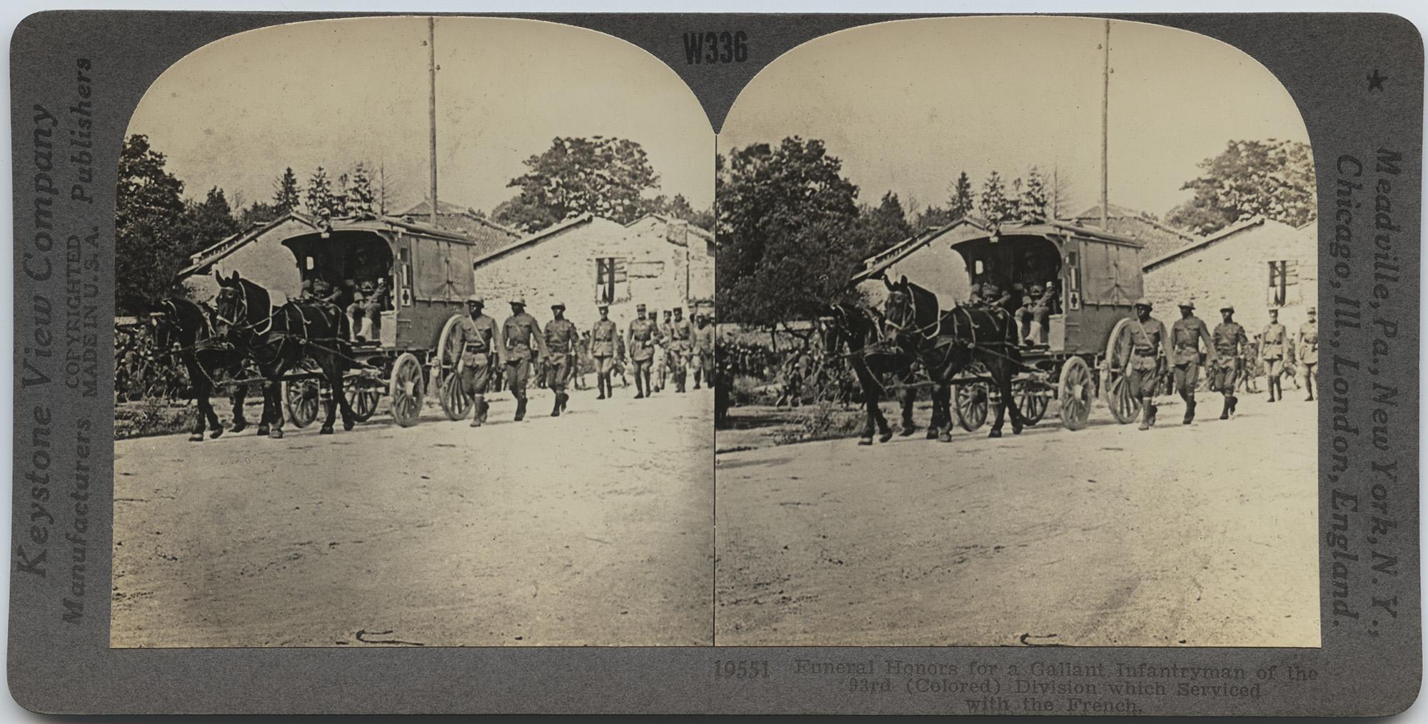 Black and white photographs of the same scene, taken moments apart, side by side, of African American soldiers walking alongside and other soldiers behind an ambulance wagon pulled by two horses, with buildings in the background. Text along the top says W336, along the sides says Keystone View Company / Manufacturers Publishers / COPYRIGHTED / MADE IN U.S.A. and Meadville, Pa., New York, N.Y., / Chicago, Ill., London, England. Text along the bottom says 19551 Funeral Honors for a Gallant Infantryman of the