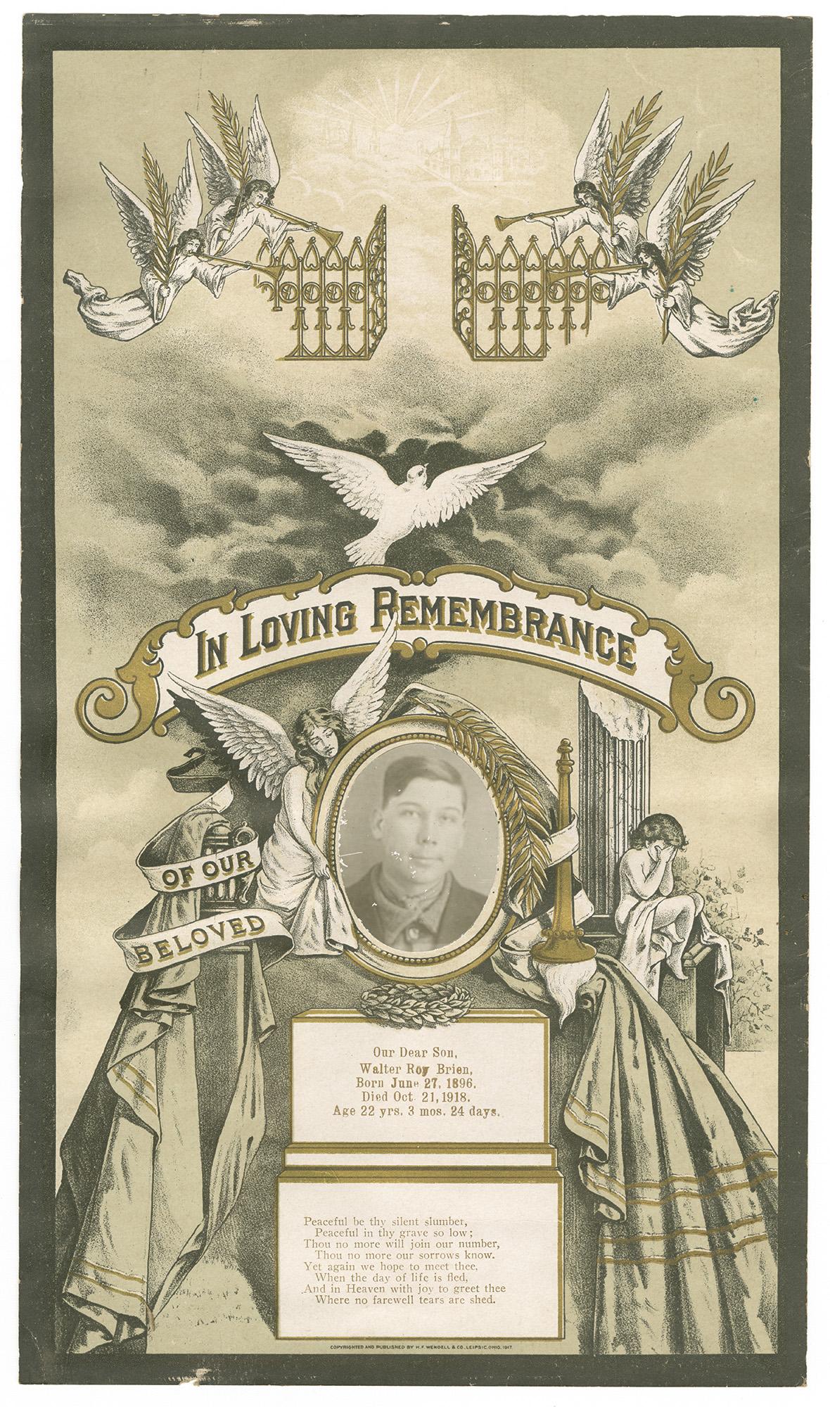 A memorial card on off-white paper with a black border. Across the top are angelic figures blowing into horns and carrying golden color plants with gates opening up to bright lights in the distance. Below the angels is a white dove flying. Below the dove a banner reads IN LOVING REMEMBRANCE with golden accents around the edges. Below the banner there is a black and white photograph of the bust of a smiling young man with a collared shirt and jacket on. Around the photograph is a golden frame with a laurel