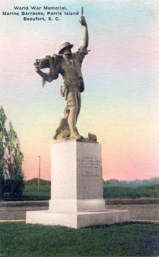 Colorized photograph of a statue of a soldier reaching one arm into the air, carrying something, and using the other arm to hold a machine gun across his shoulders. The statue sits atop an engraved pedestal in a grassy area with a paved area behind it. In the background is a colorful sky, a tree, and an open field. Text in the top left corner reads World War Memorial, / Marine Barracks, Parris Island / Beaufort, S. C.